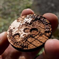 Laser engraved token made from cherry wood. It shows a small section of moon topography.