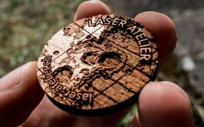 Laser engraved token made from cherry wood. It shows a small section of moon topography.